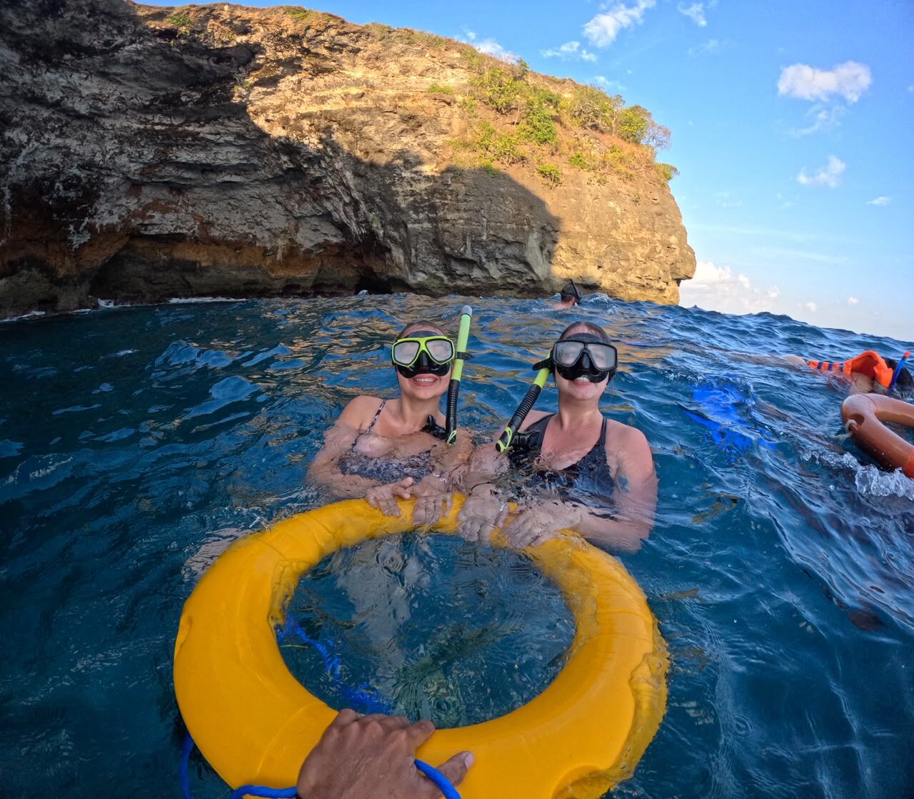 Guests snorkeling beside the cliffs of Nusa Lembongan